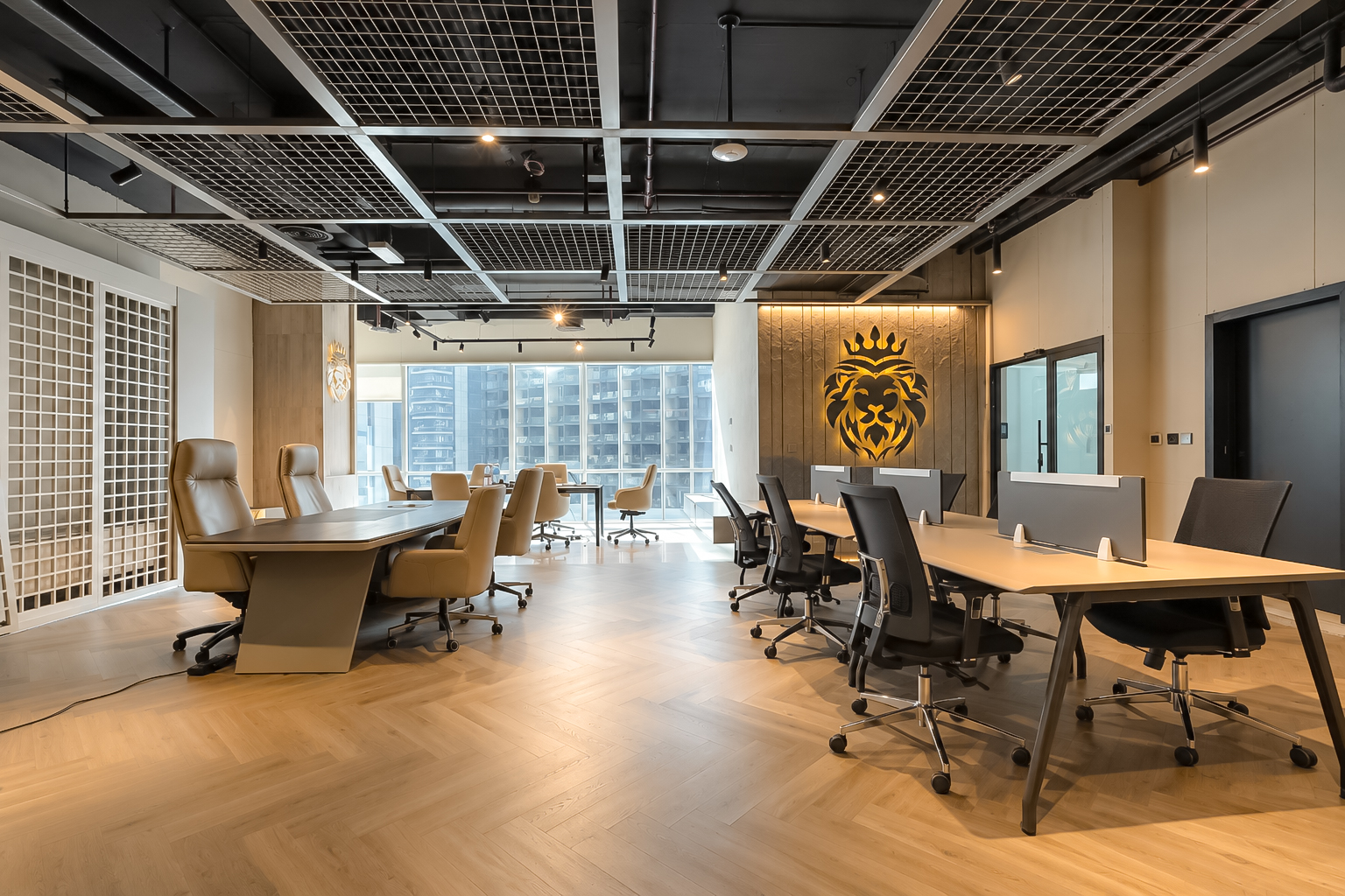 Open work floor with board table, workstations, and city views