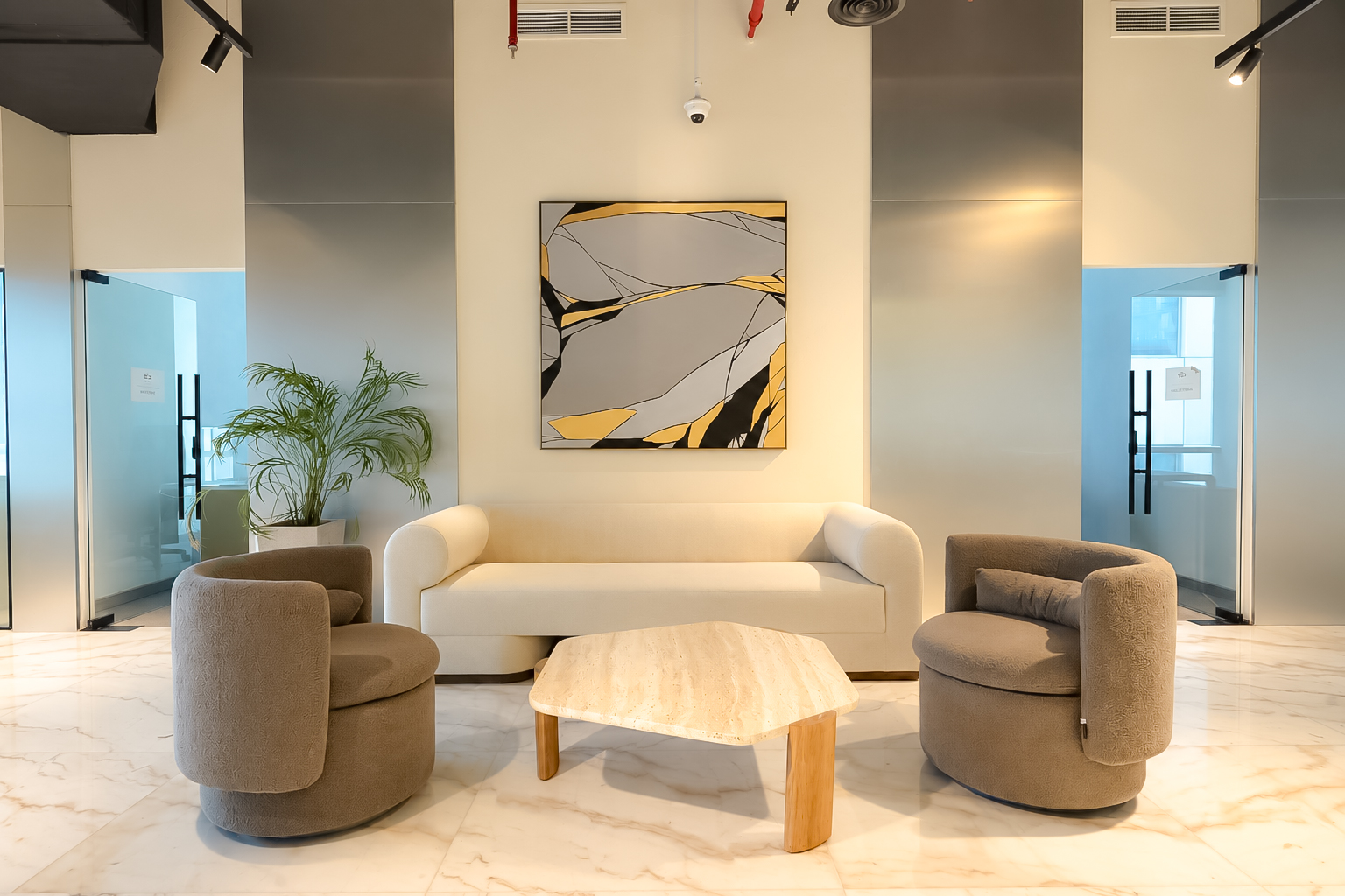 Marble arrival lounge with cream sofa and travertine table