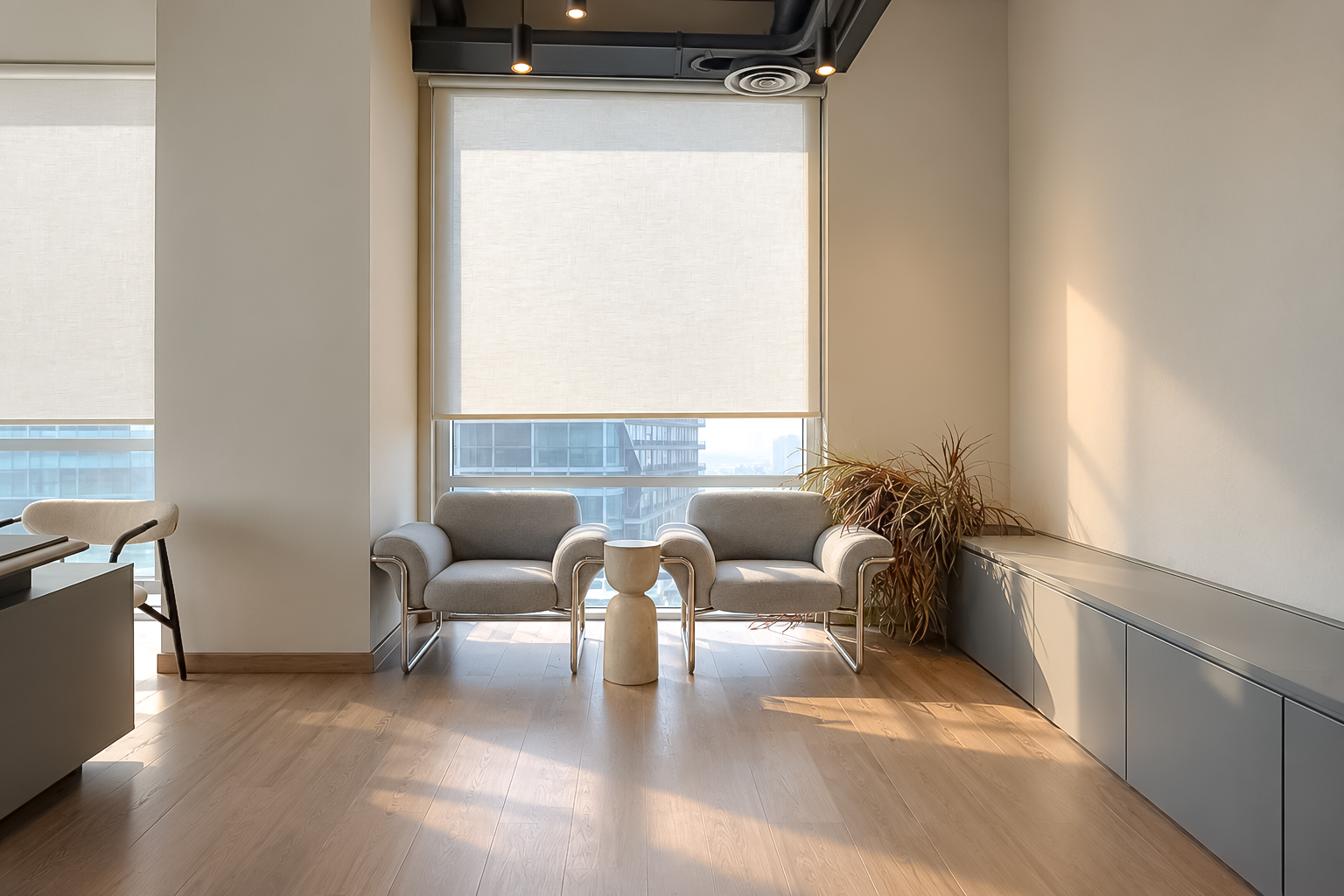 Window lounge with grey lounge chairs and stone side table