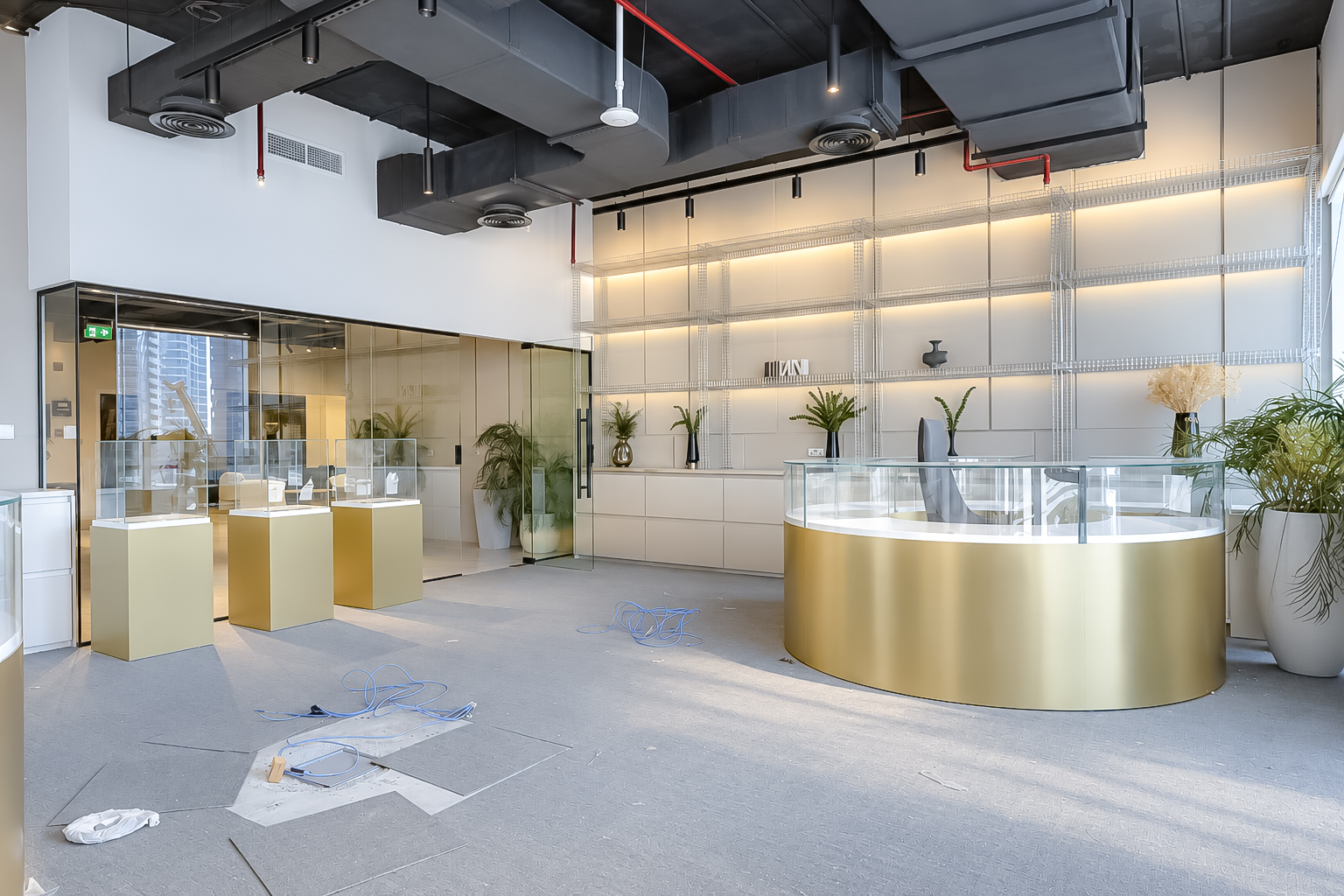 Gold circular showroom counter with glass vitrines