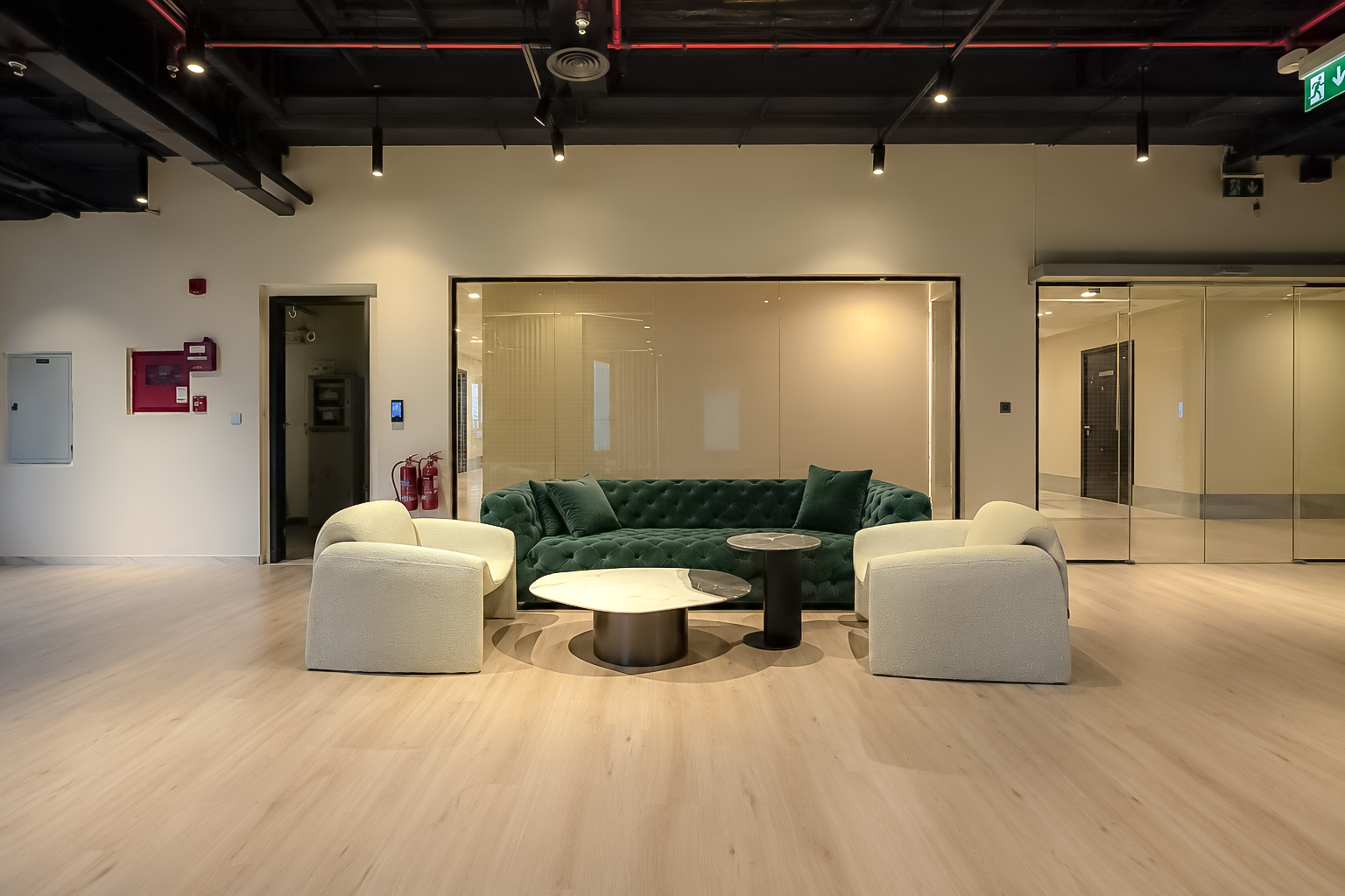 Emerald tufted sofa and cream boucle chairs